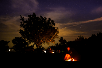 Lady sat near a firepit 